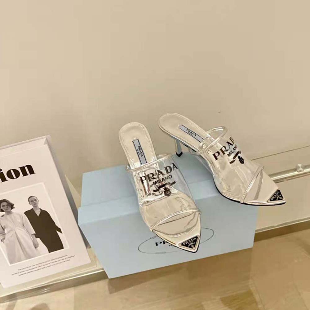 Close-up of silver Plexiglas and embossed Prada logo on high-heel slide