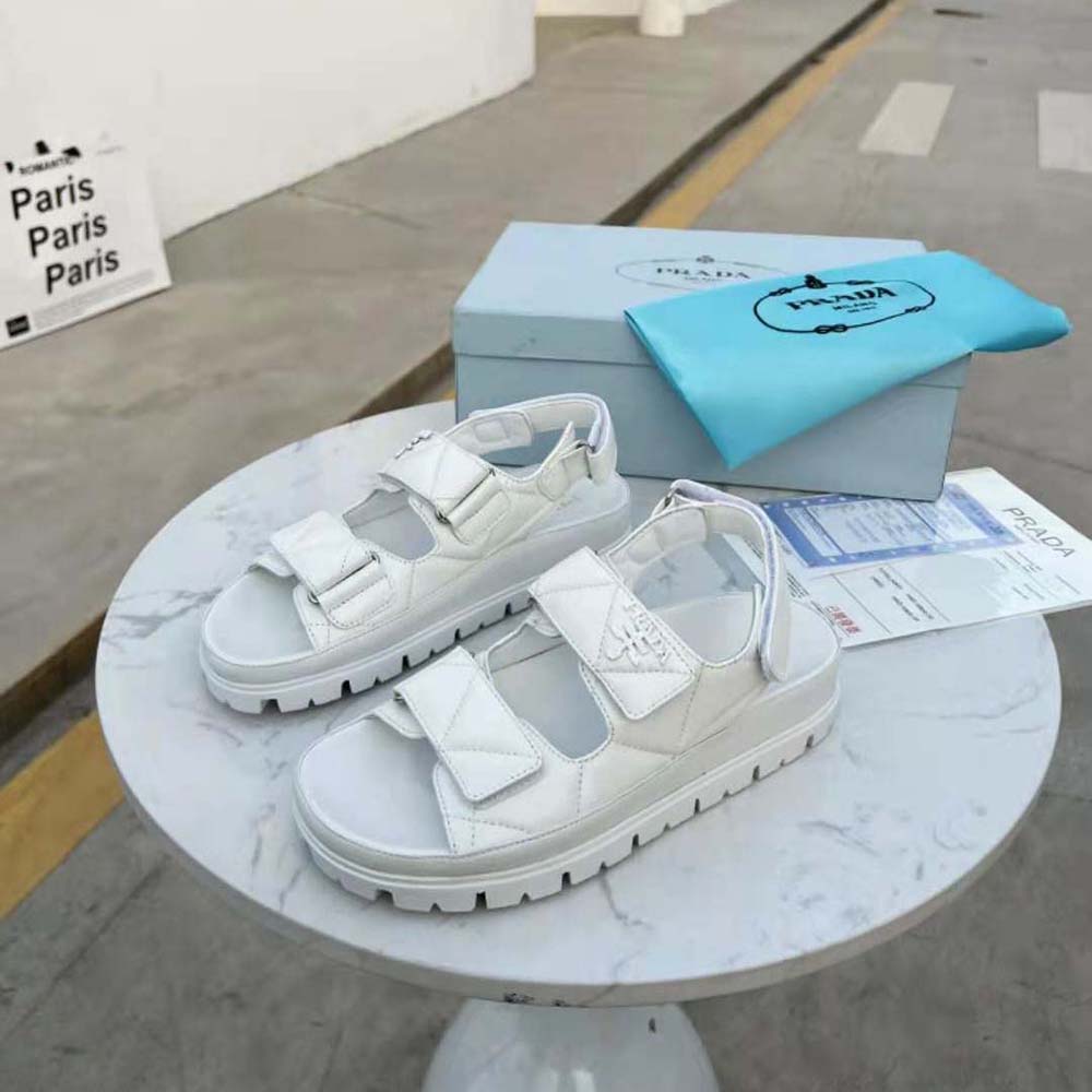 Top-down detail showing adjustable buckle on Prada leather sandals