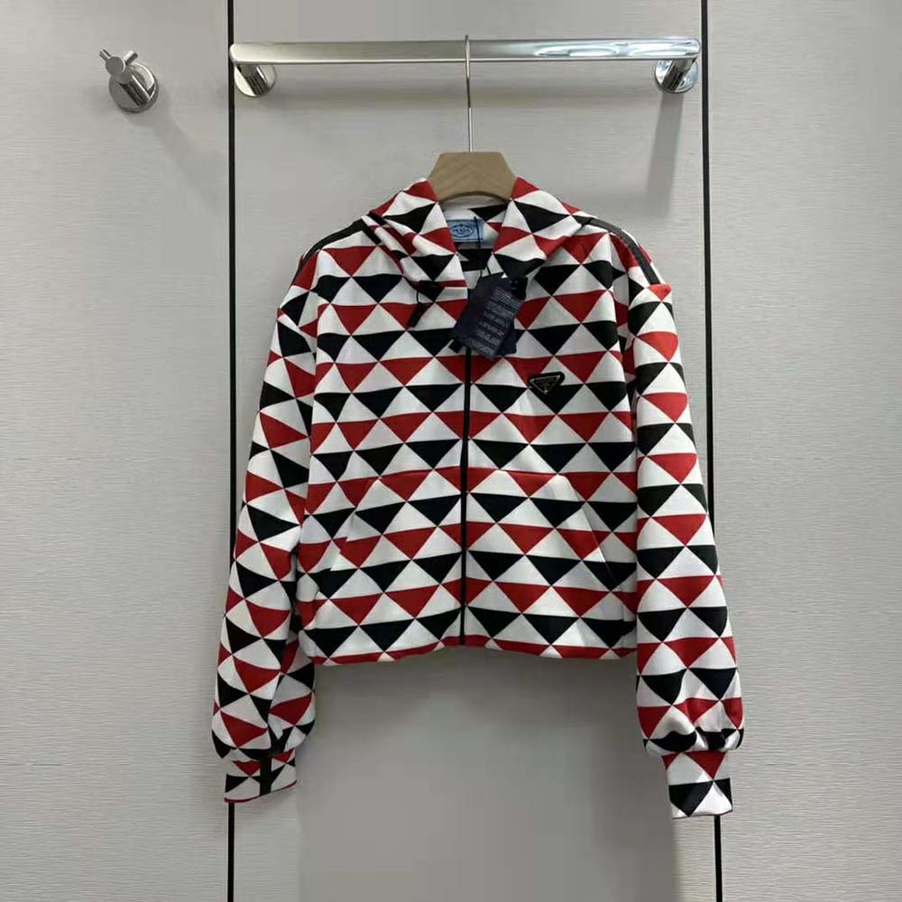Close-up of red jersey fabric and printed logo on Prada hoodie
