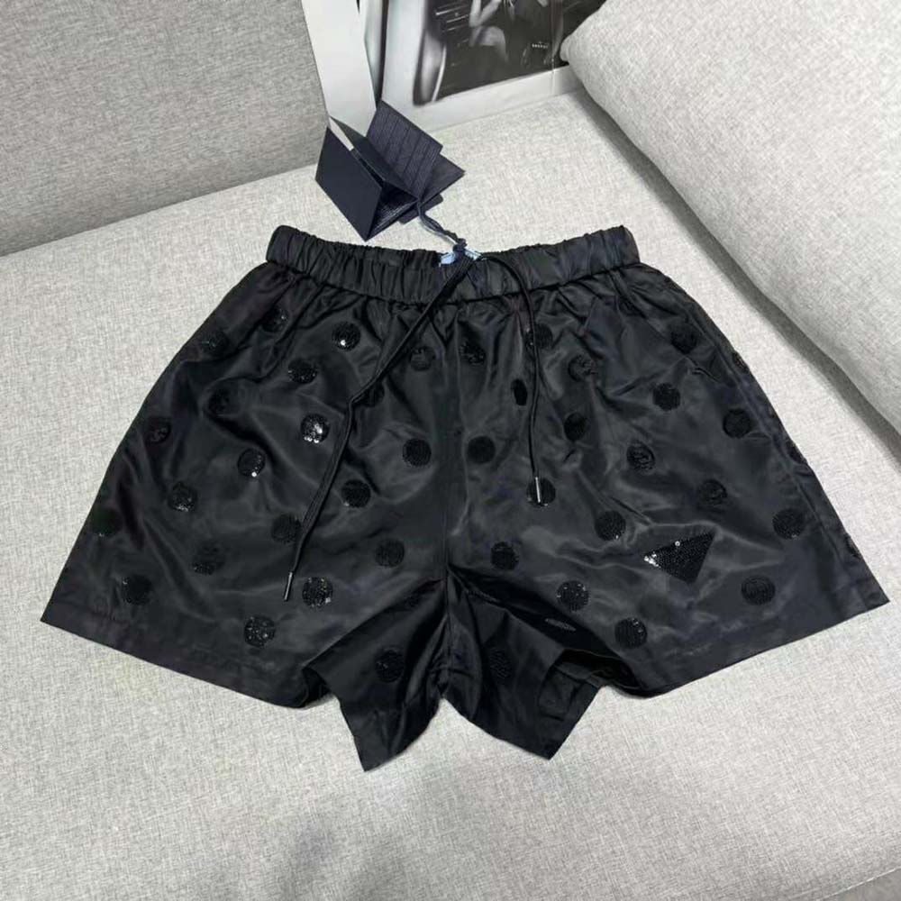 Close-up on Prada logo hardware on Prada Women Re-Nylon Sequin Shorts-Black