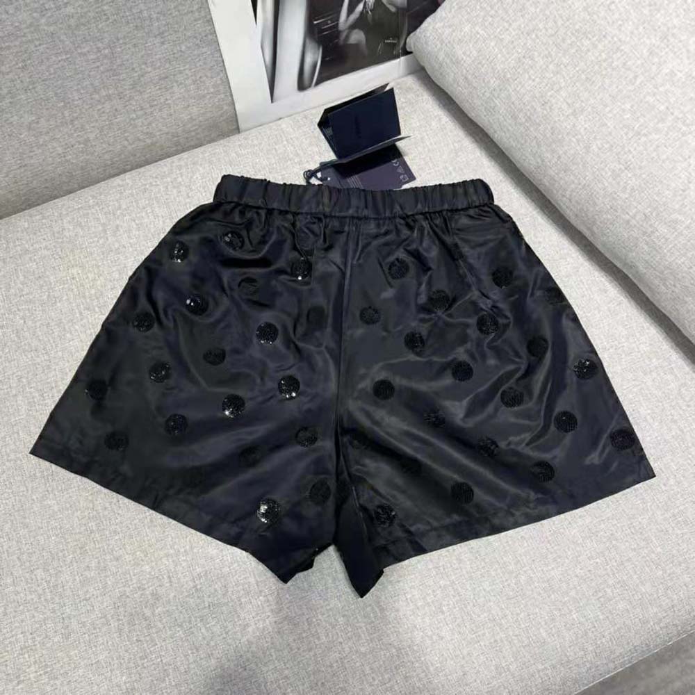 Side angle of Prada Women Re-Nylon Sequin Shorts-Black highlighting silhouette