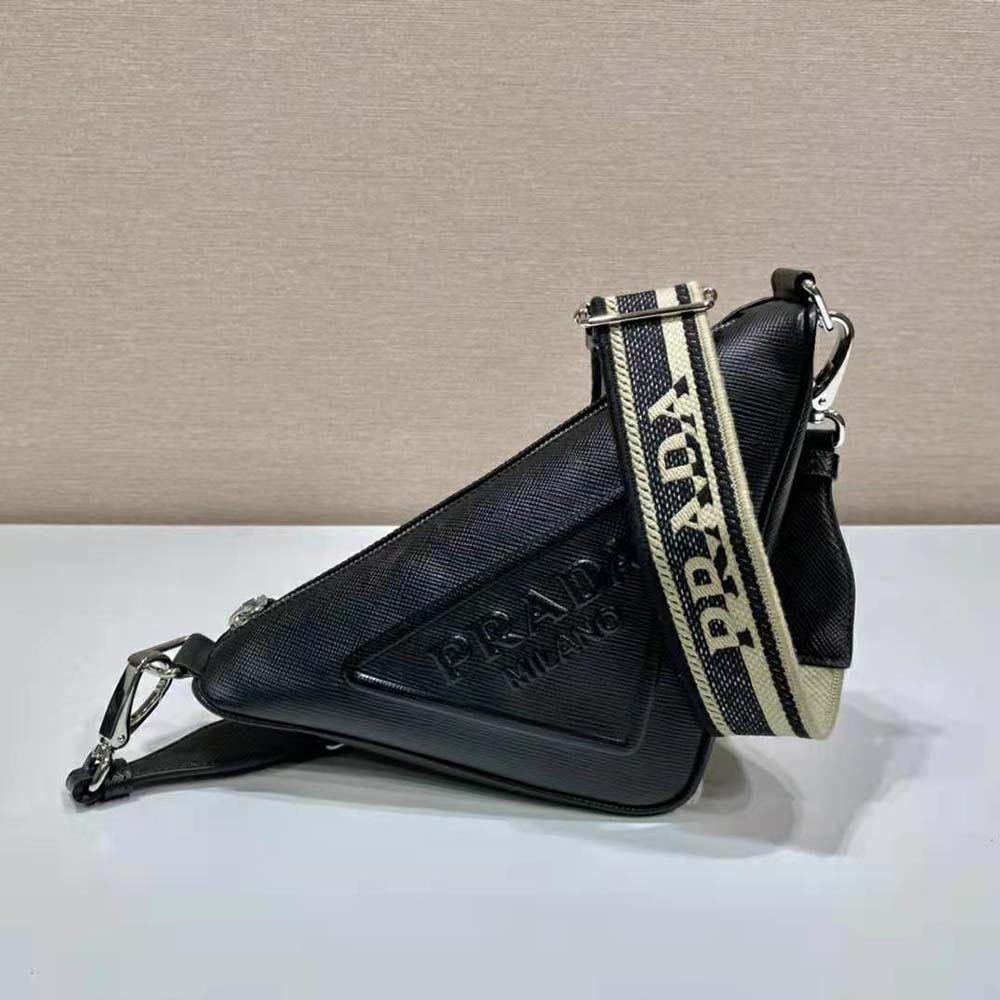 Close-up of silver Prada triangle logo on black Saffiano leather