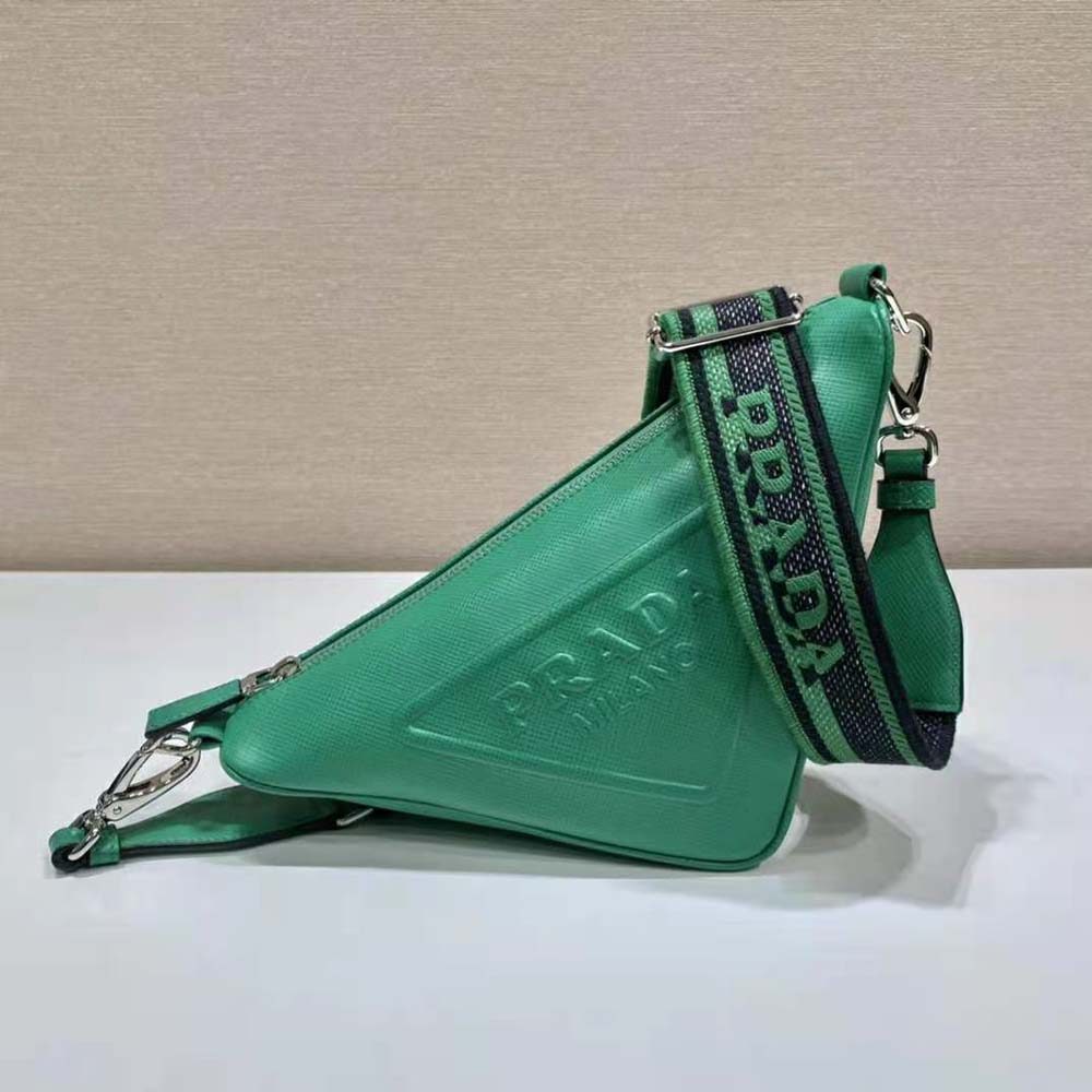 Close-up on silver-tone hardware and Prada logo of green triangle bag
