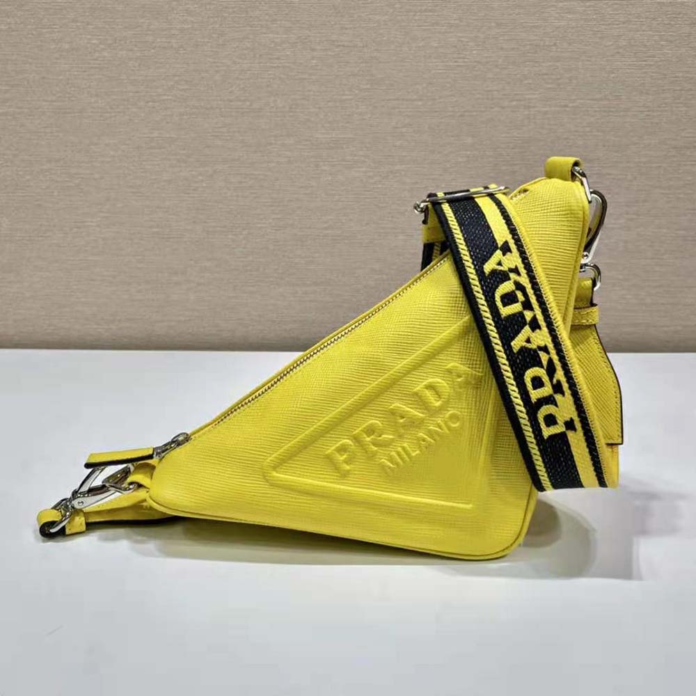 Close-up of Prada triangle logo on yellow saffiano leather bag