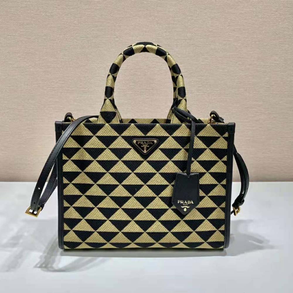 Close-up of gold-tone Prada Symbole hardware on brown jacquard handbag
