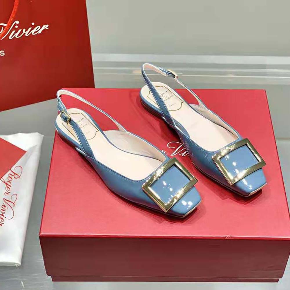Close-up of metal buckle detail on Roger Vivier blue patent leather ballerinas