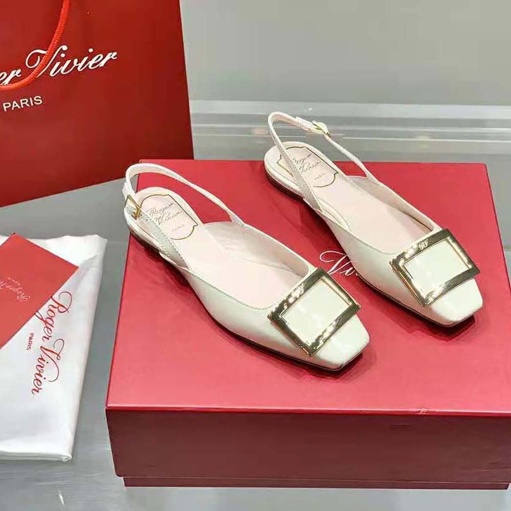Close-up on metal buckle detail of Roger Vivier Trompette white slingback ballerinas
