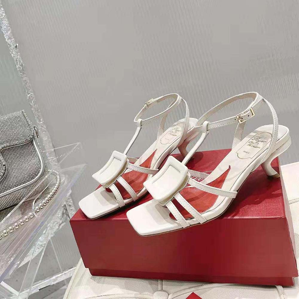 Top angle showing ankle strap and heel of Roger Vivier white sandals