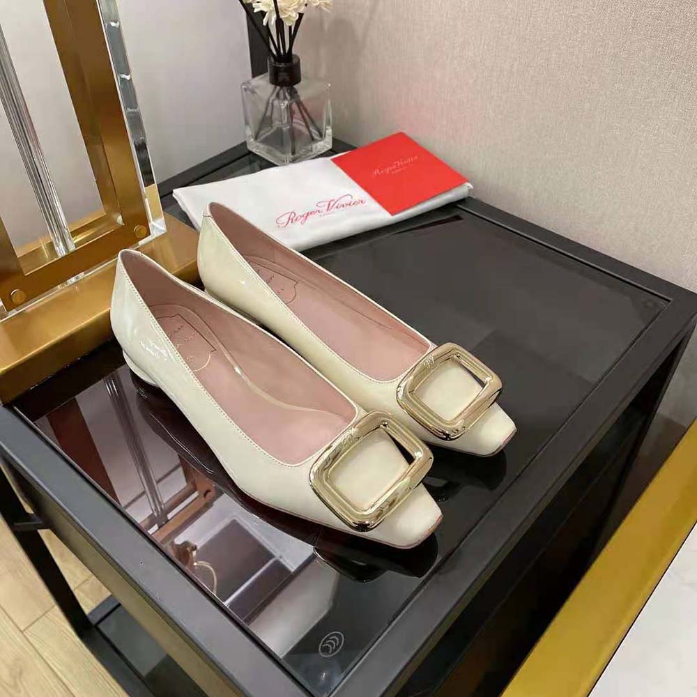 Side profile showing silhouette of white patent leather Roger Vivier ballerinas