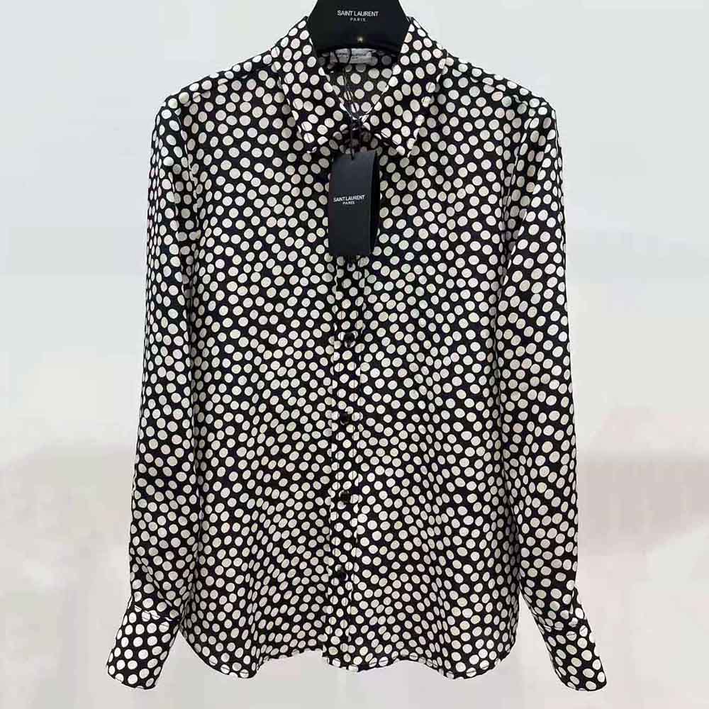 Close-up of dotted silk texture and YSL logo embroidery on black shirt