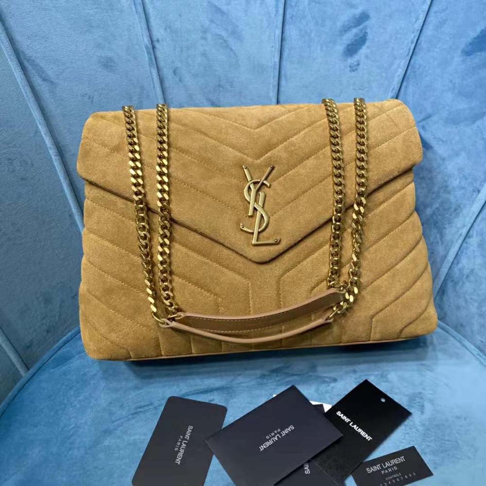 Close-up of Y-quilted suede and gold YSL hardware detail