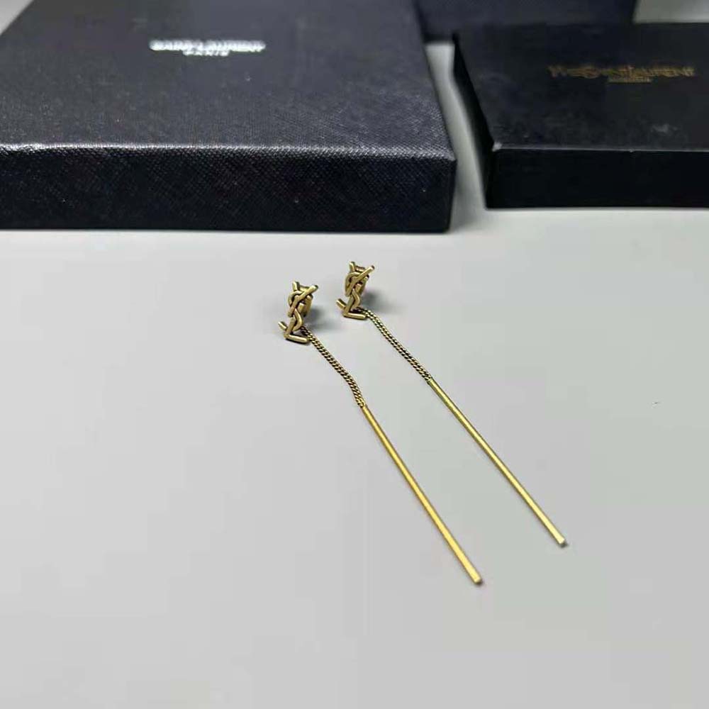 Elegant shot of Saint Laurent YSL Women Opyum YSL Threader Earrings worn