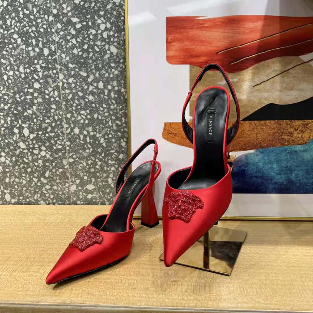 Rear angle showing adjustable buckle strap on Versace La Medusa red pumps