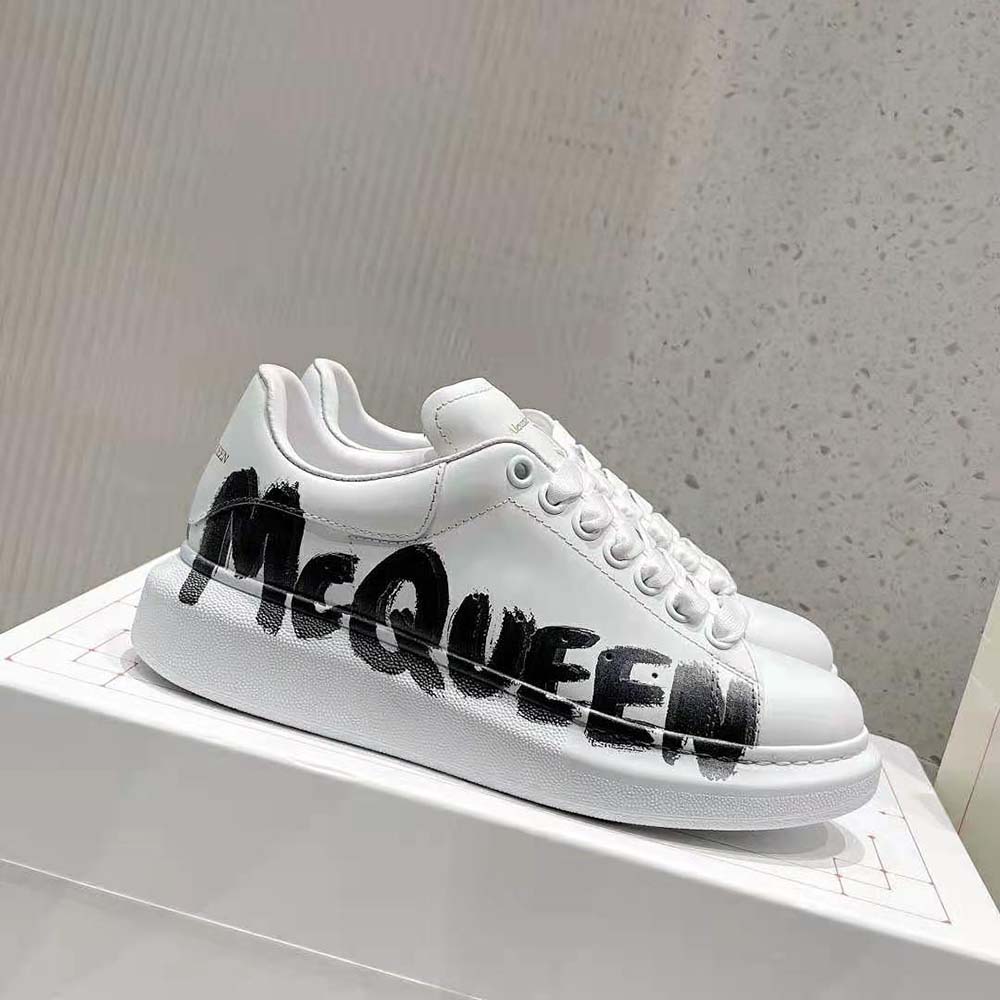 Close-up on black graffiti print detail of Alexander Mcqueen oversized sneaker