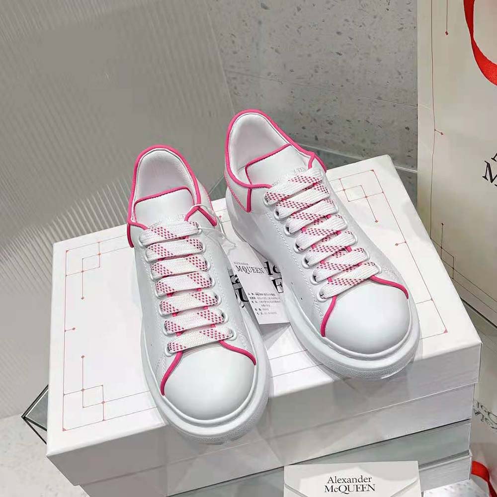 Close-up of neon pink leather and branded heel detail sneaker