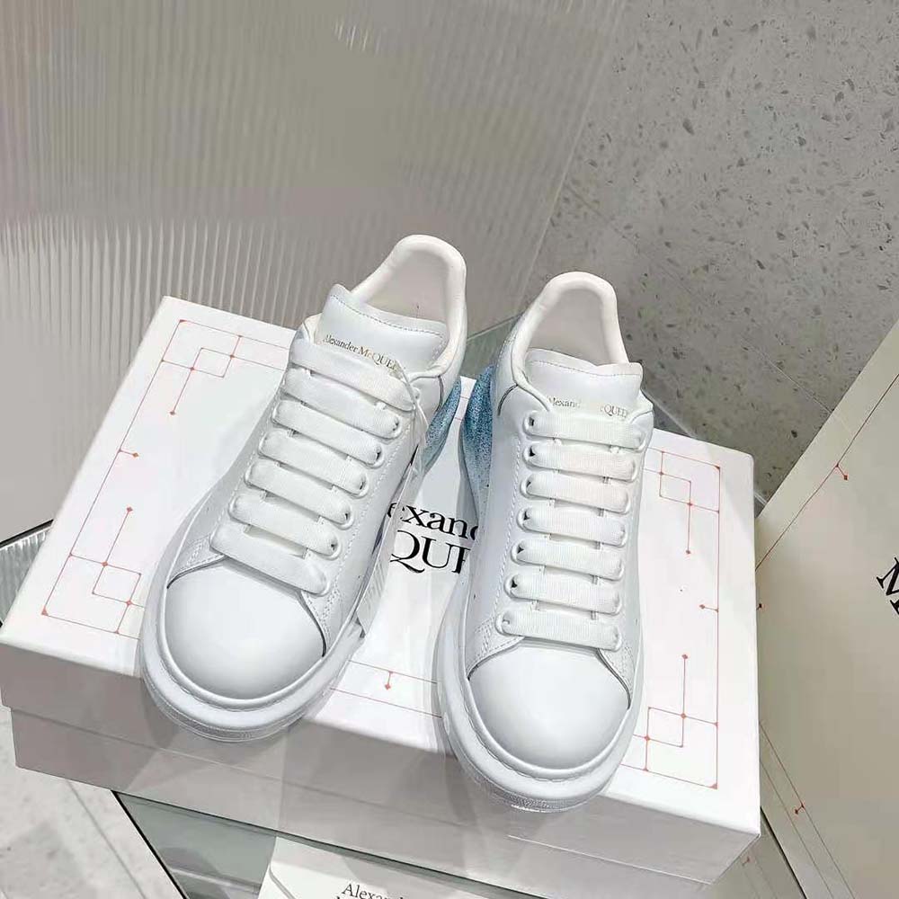 Side profile showing chunky sole and blue accents of Alexander Mcqueen sneaker