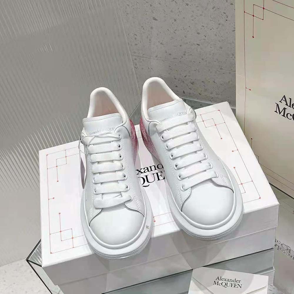 Close-up on pink leather accent and logo of Alexander Mcqueen Women Oversized Sneaker