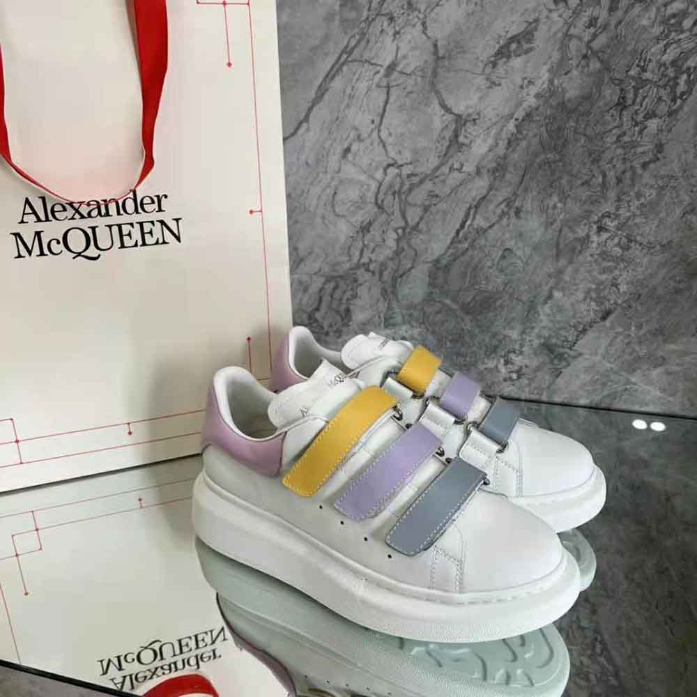 Close-up of triple straps with branded hardware on Alexander Mcqueen sneaker