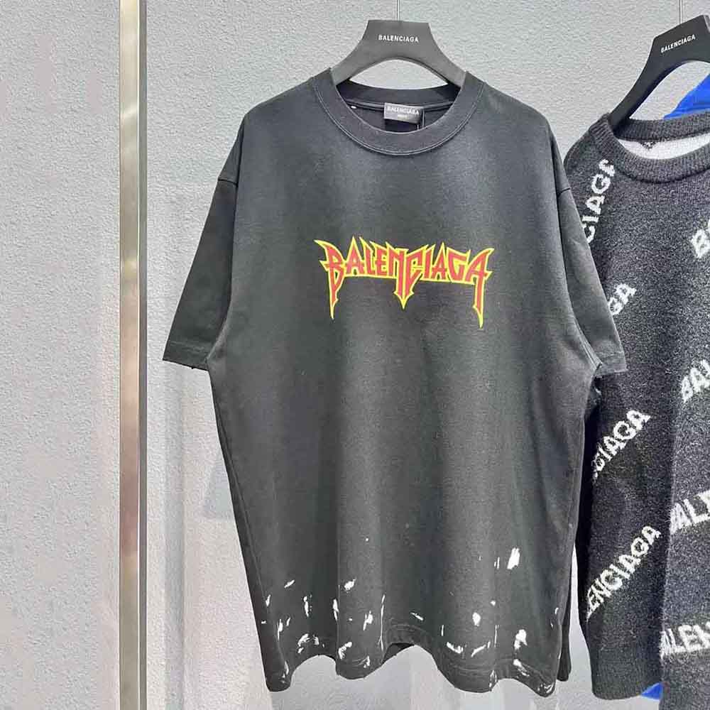 Close-up detail of metal logo hardware on black vintage jersey t-shirt