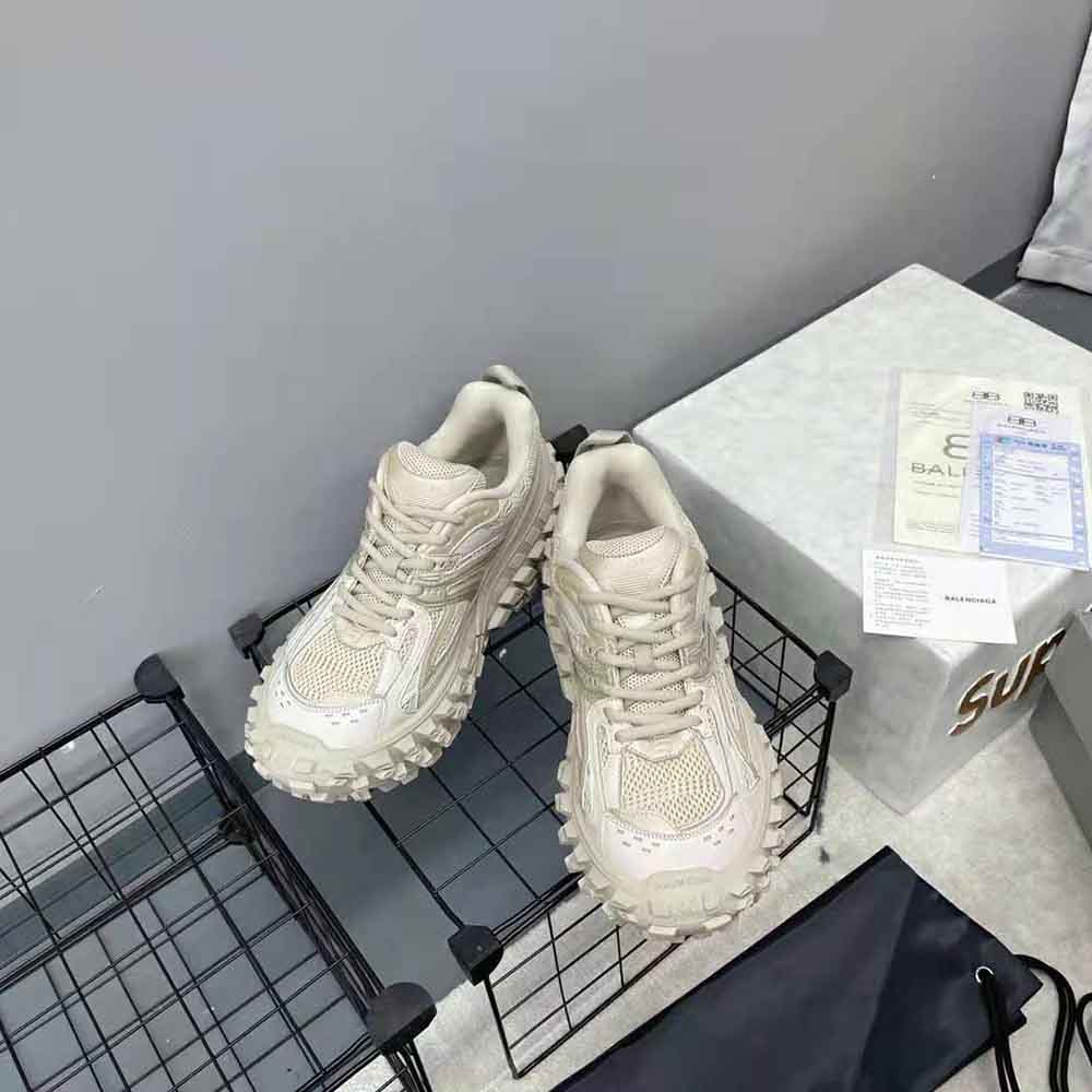 Top-down angle showing beige mesh upper of Balenciaga Unisex Defender Sneaker