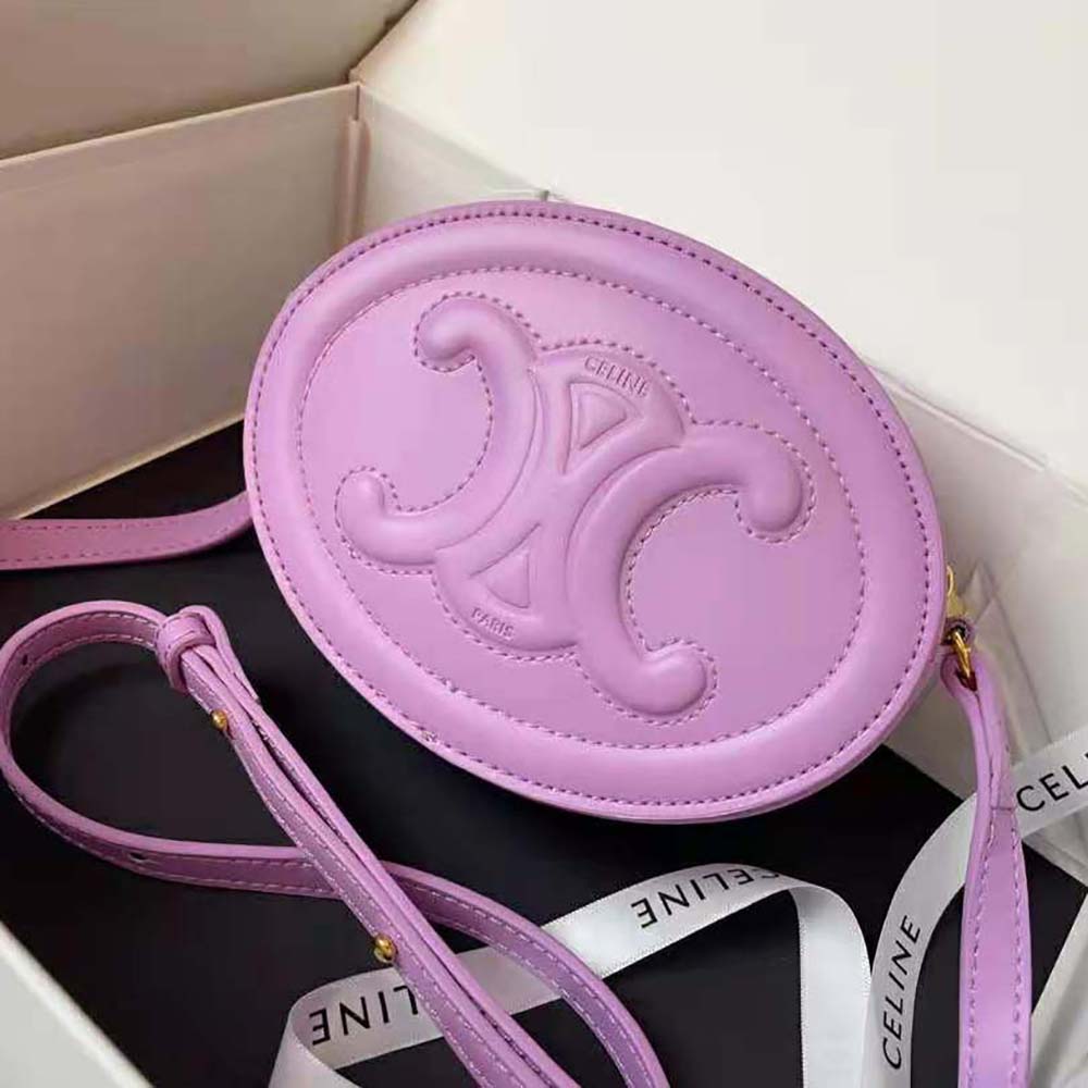Close-up of gold Triomphe clasp on Celine crossbody oval purse purple leather