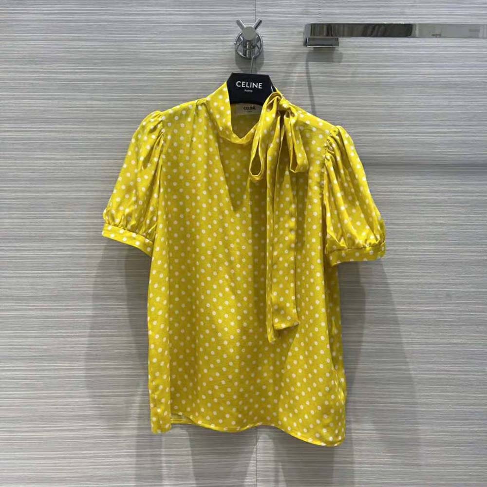 Close-up of lavalliere tie detail on Celine yellow blouse