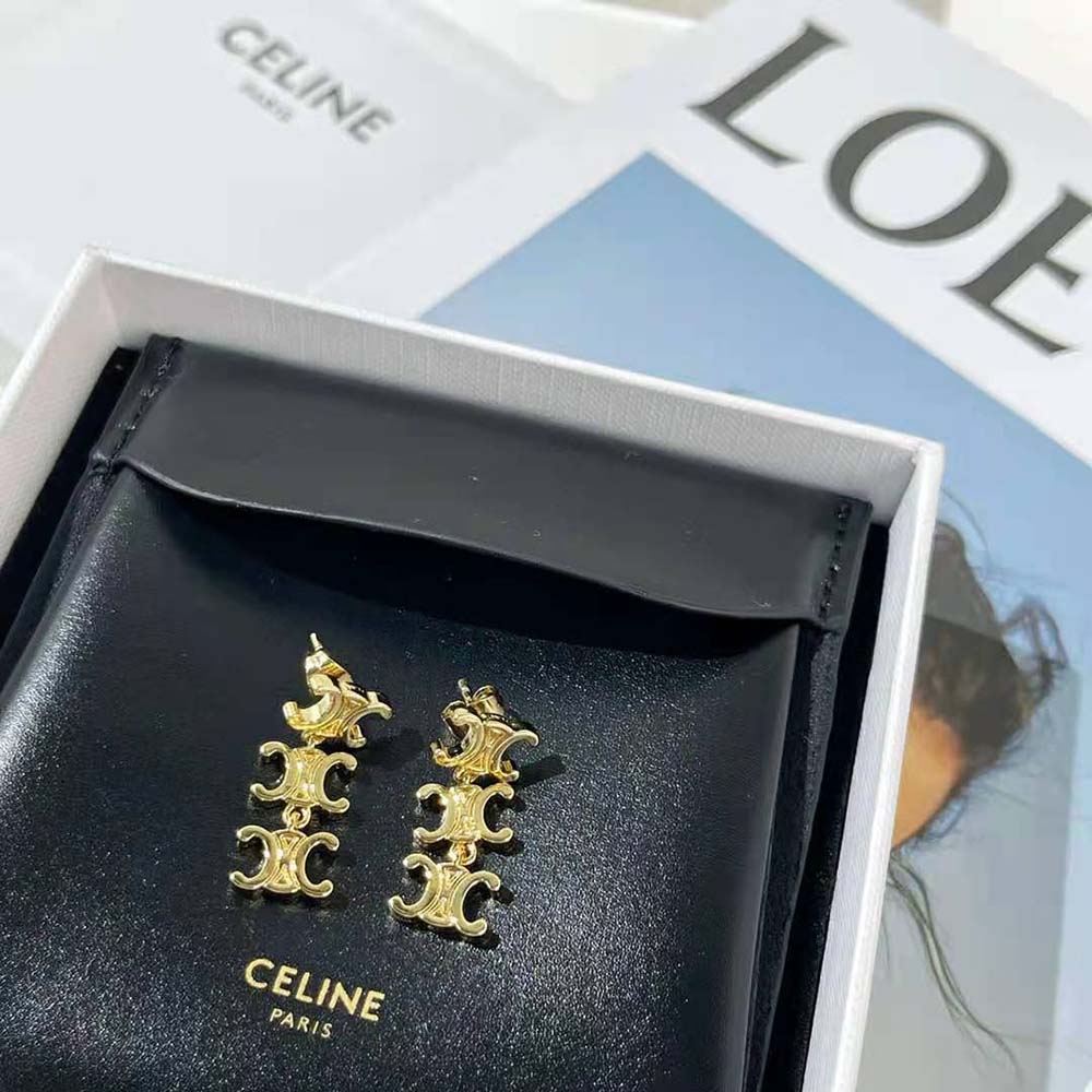Close-up detail of gold brass and Triomphe logo on Celine earrings