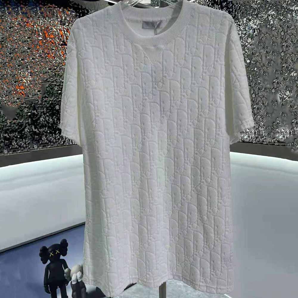 Close-up detail of Dior Oblique jacquard pattern on t-shirt fabric