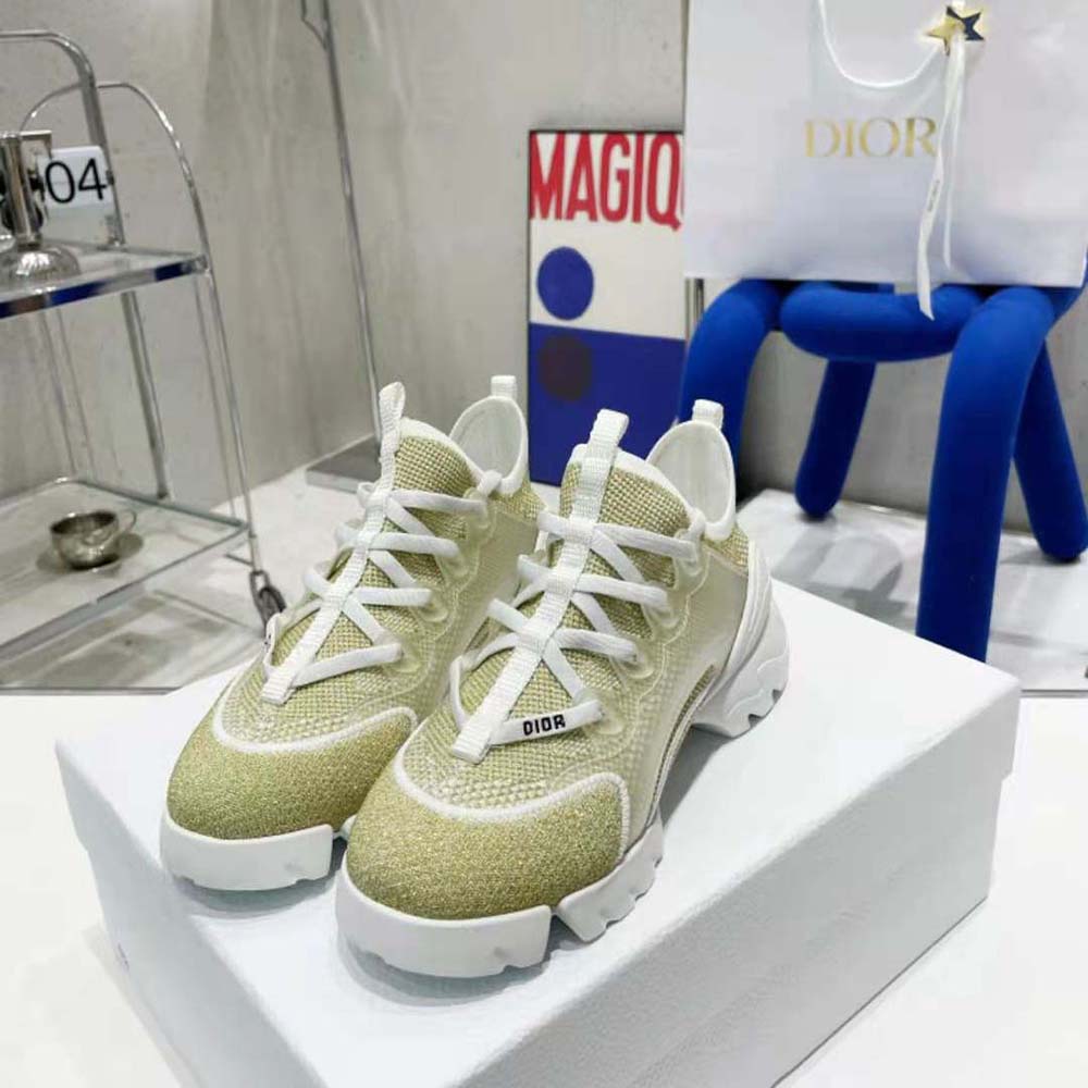 Close-up of gold logo hardware on Dior Women D-Connect Sneaker