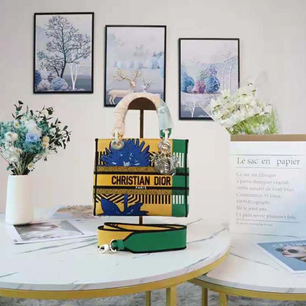 Close-up of D-Flower green embroidery on bright yellow Dior Lady D-lite bag