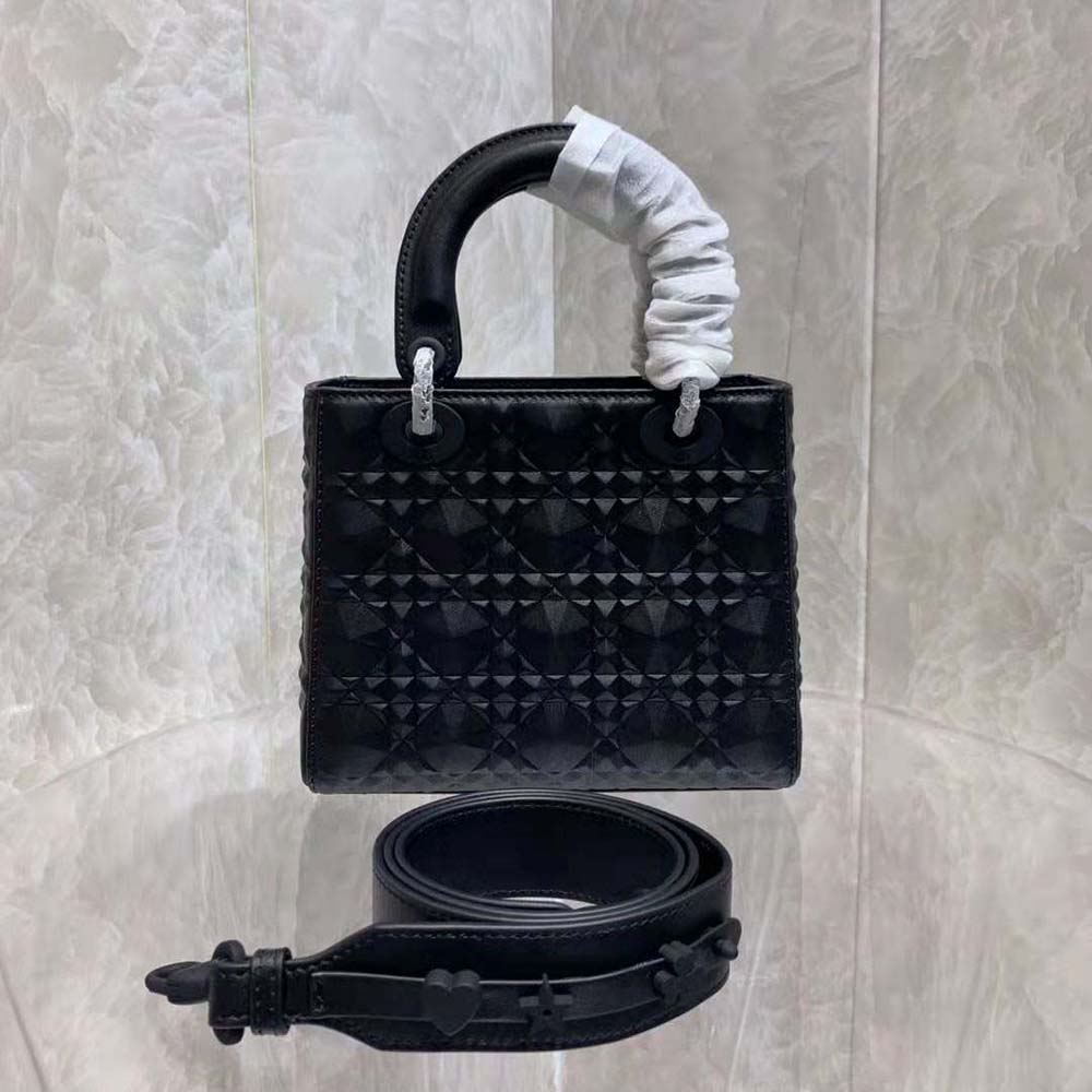 Side profile showing quilted texture of Dior Women Mini Lady Dior Bag in black leather