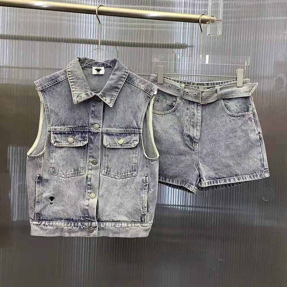 Close-up on signature Dior buttons on sleeveless denim jacket