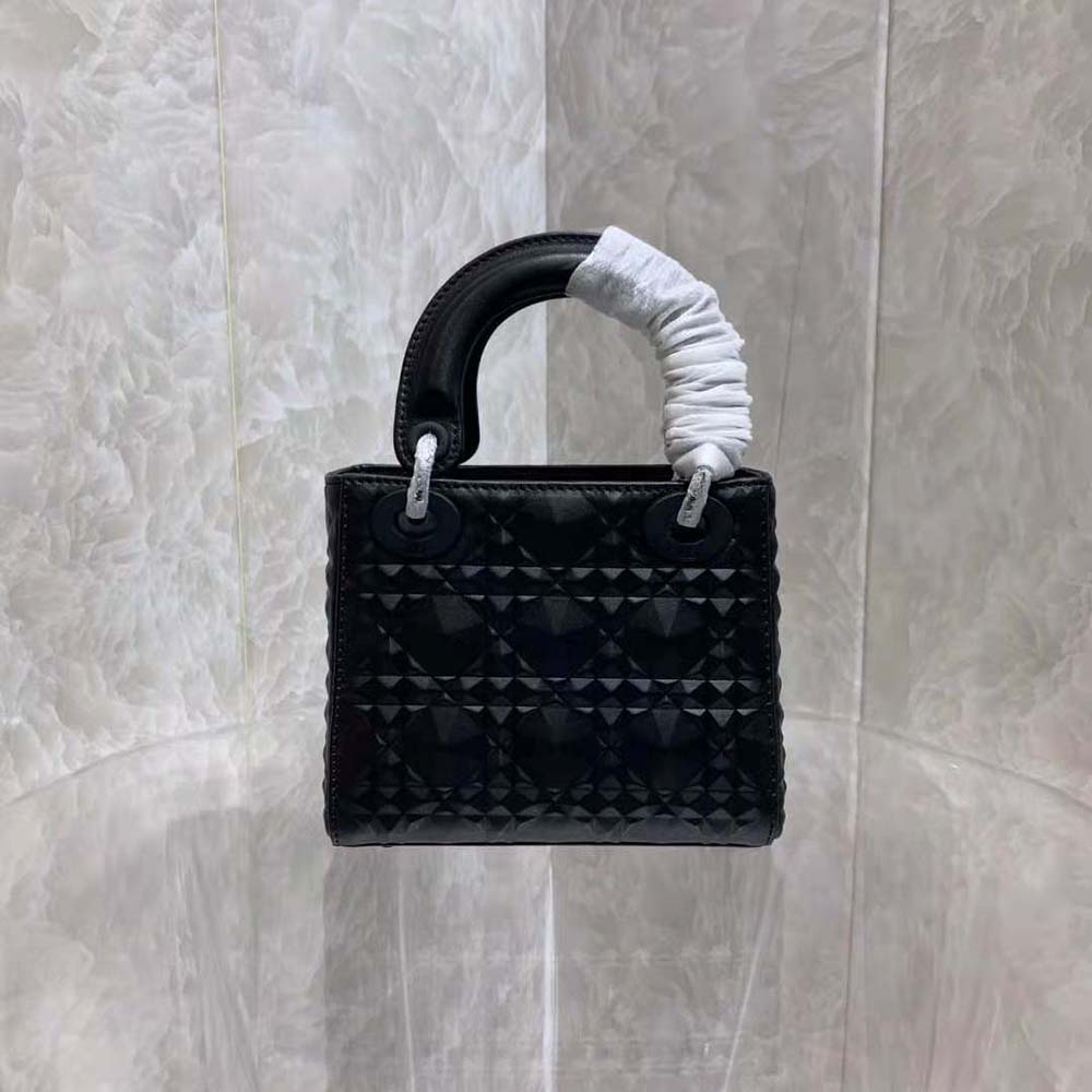 Side angle showing silver-tone hardware and flap closure on Dior Women Small Lady Dior my Abcdior Bag