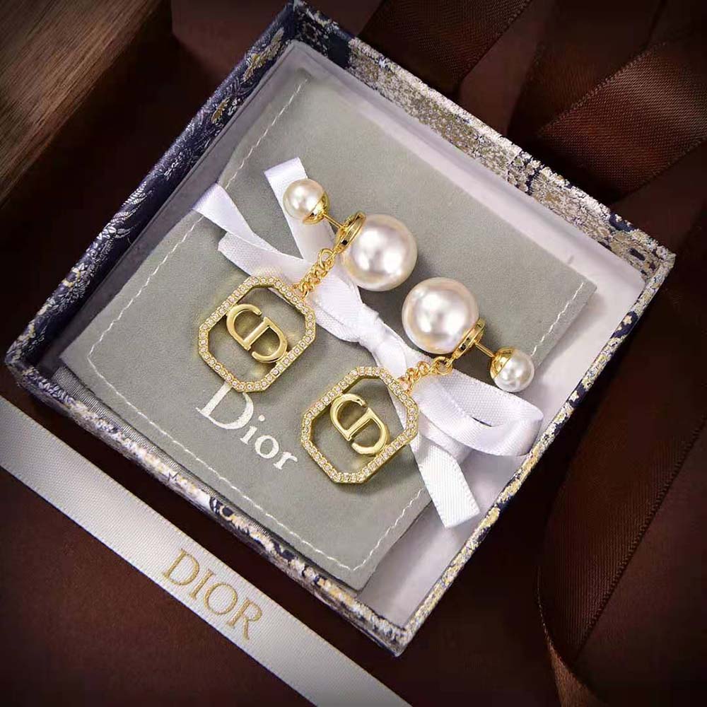 Side profile showing gold-finish metal and closure of Dior Women Tribales Earrings