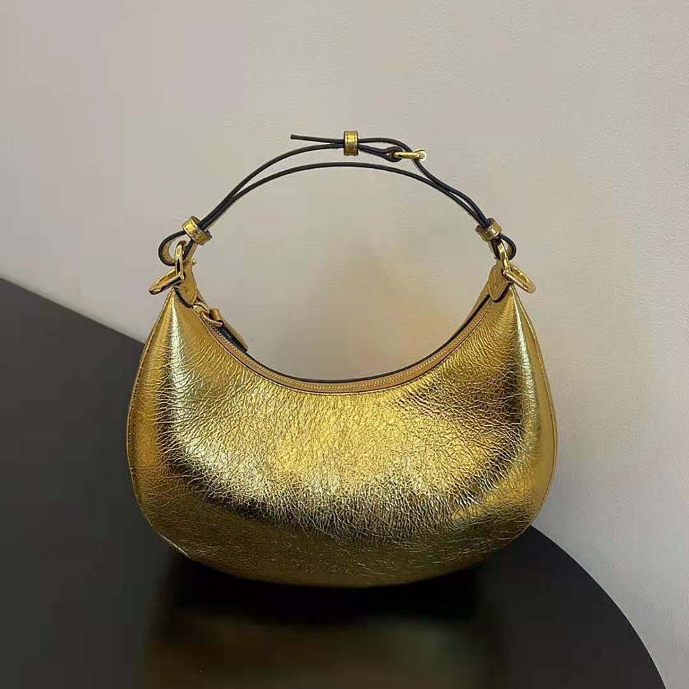 Close-up of gold embossed Fendigraphy hardware on leather bag