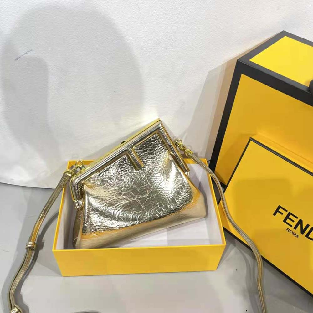 Close-up of gold laminated leather and signature Fendi clasp detail