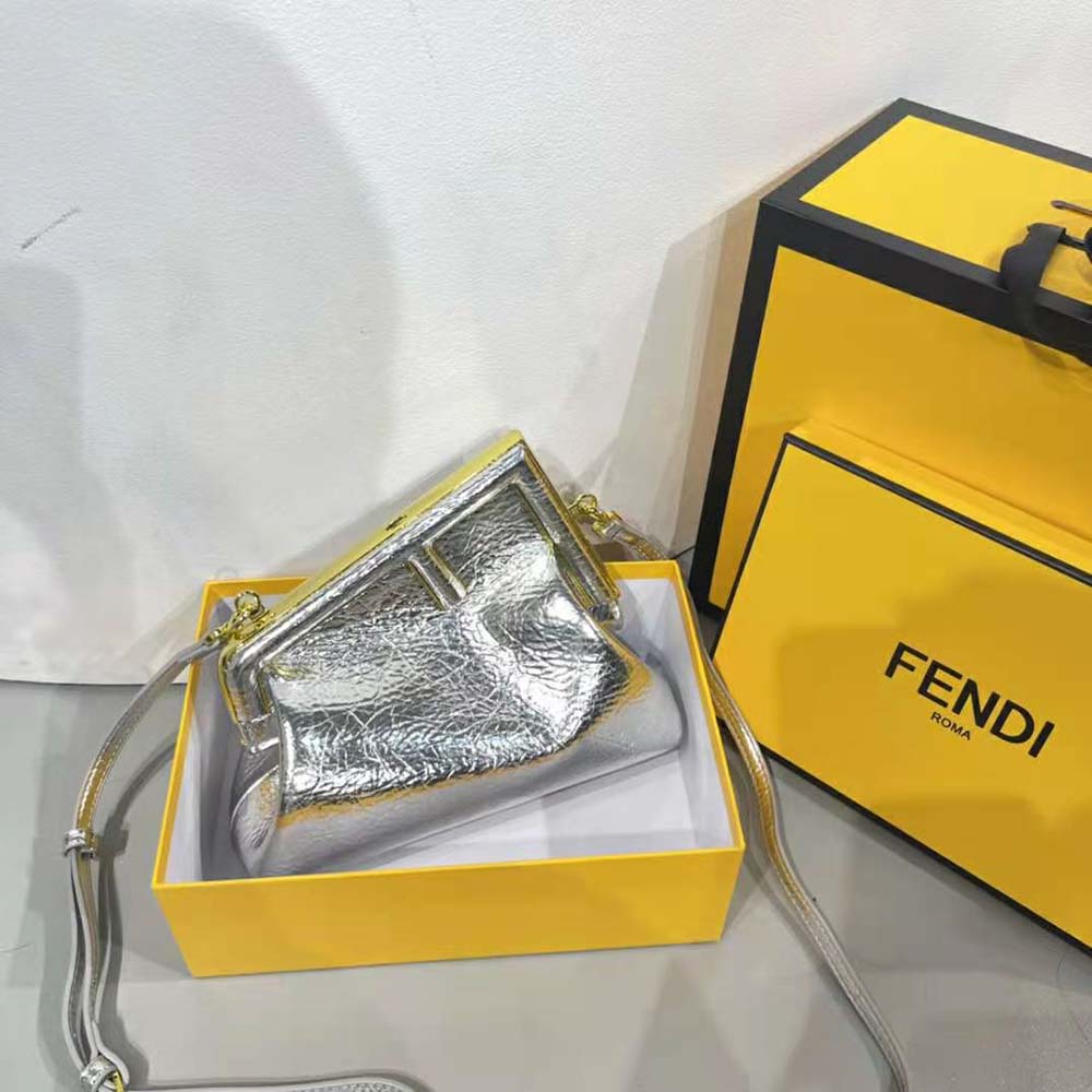 Close-up of Fendi logo detail on small silver laminated leather bag