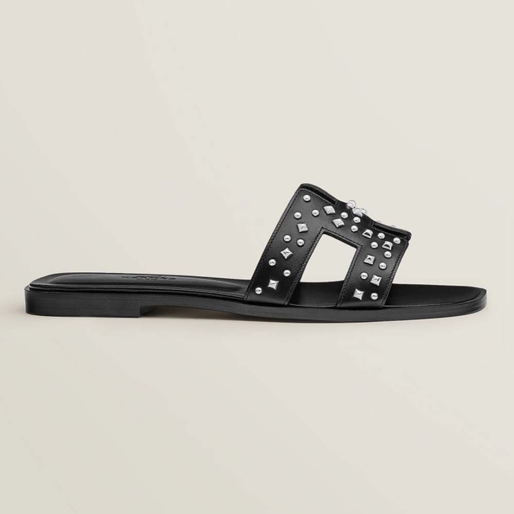 Side view of Hermes Women Oran Sandal in Calfskin Black