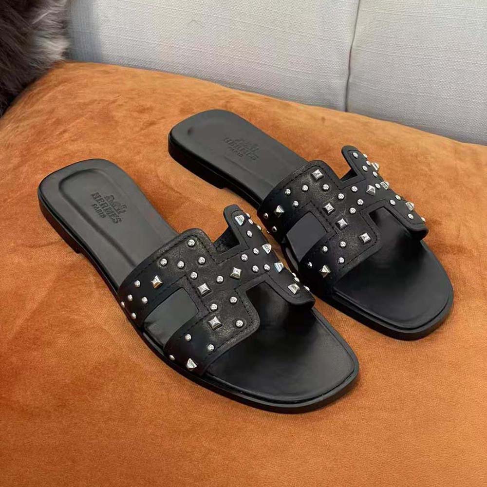 Top angle showing sleek black leather of Hermes Women Oran Sandal