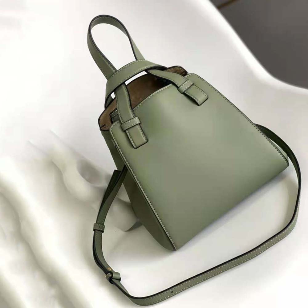 Side view showing curved silhouette of Loewe Women Hammock Nugget Bag