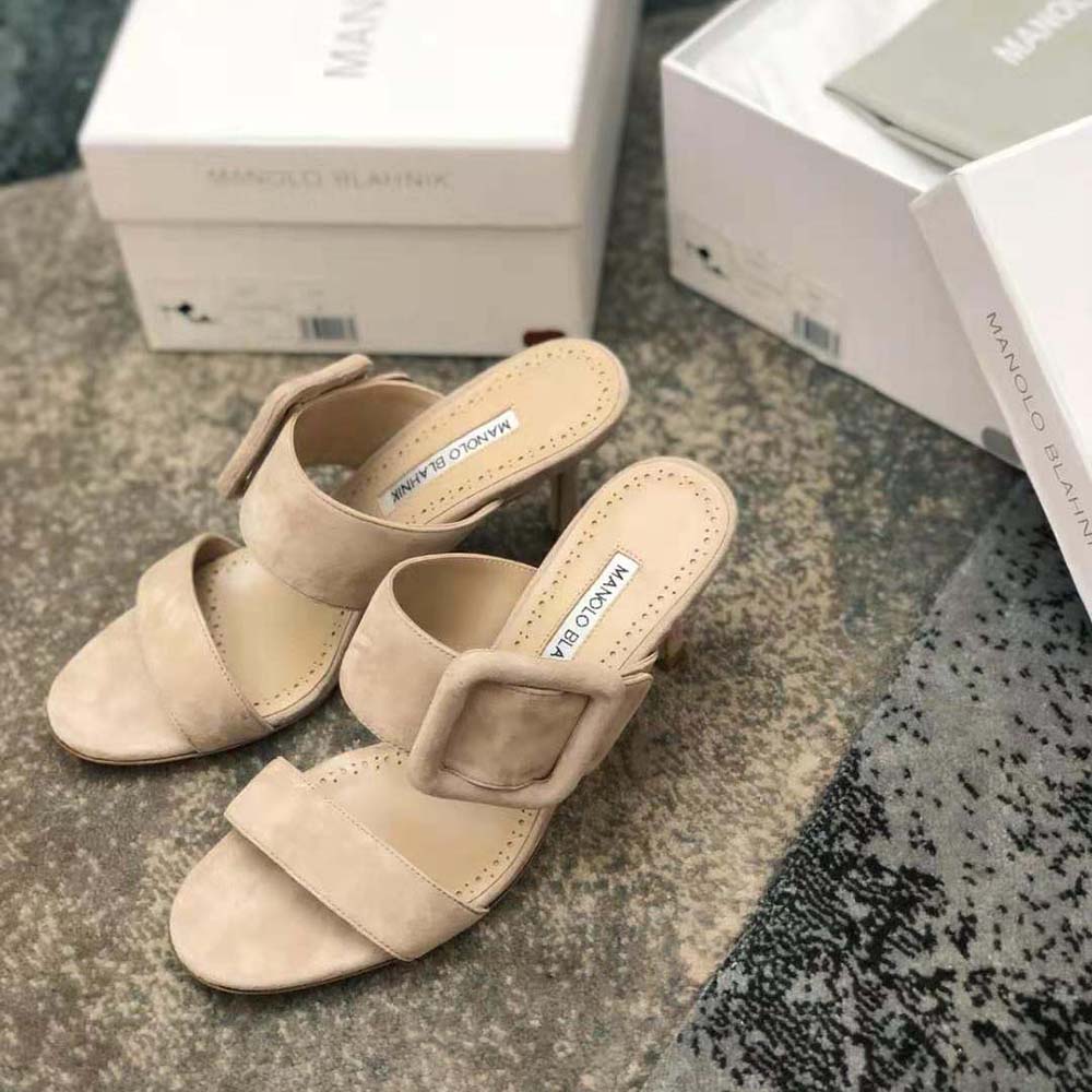 Rear angle showcasing heel height and elegant silhouette of Manolo Blahnik mules