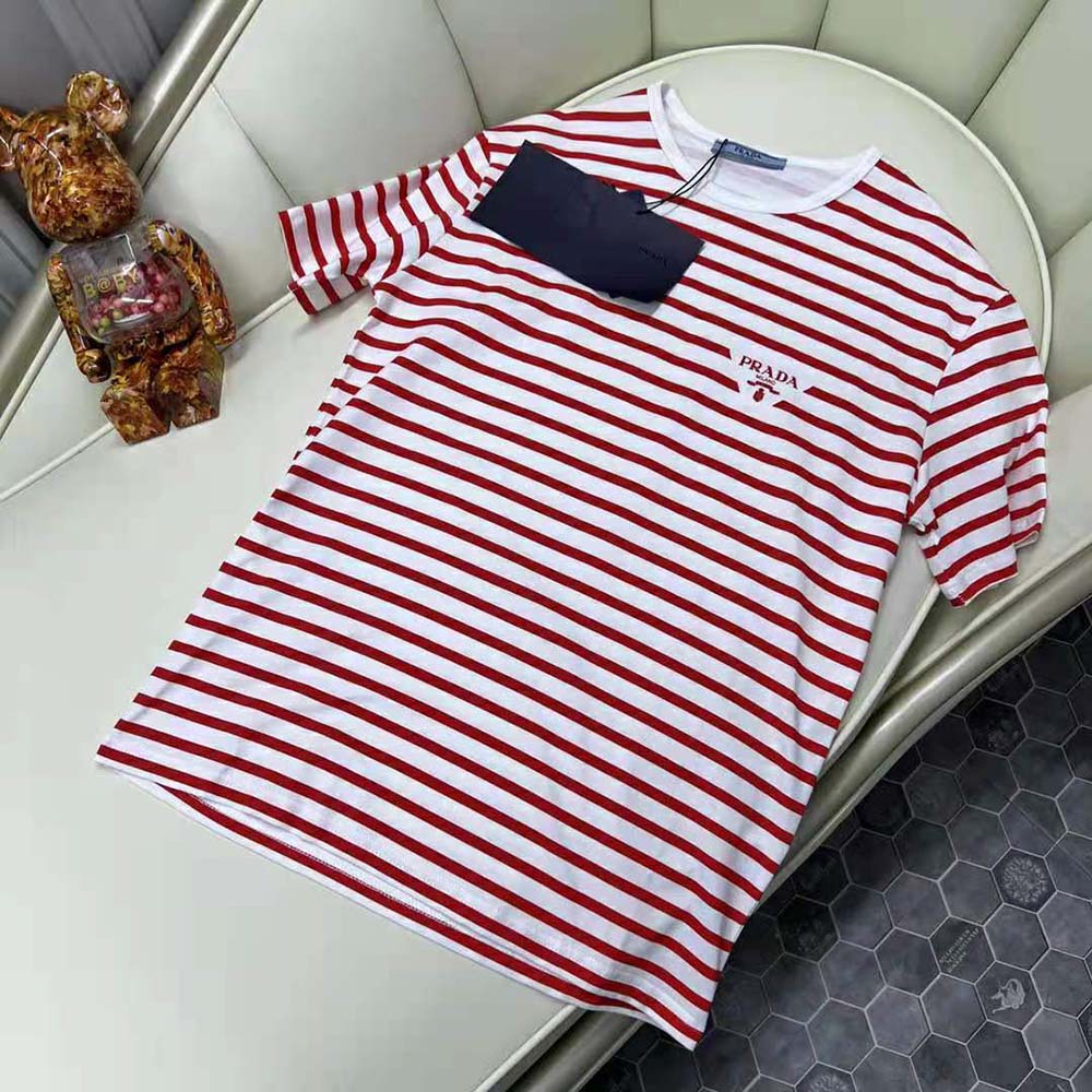 Close-up detail of red cotton fabric and Prada logo on T-shirt