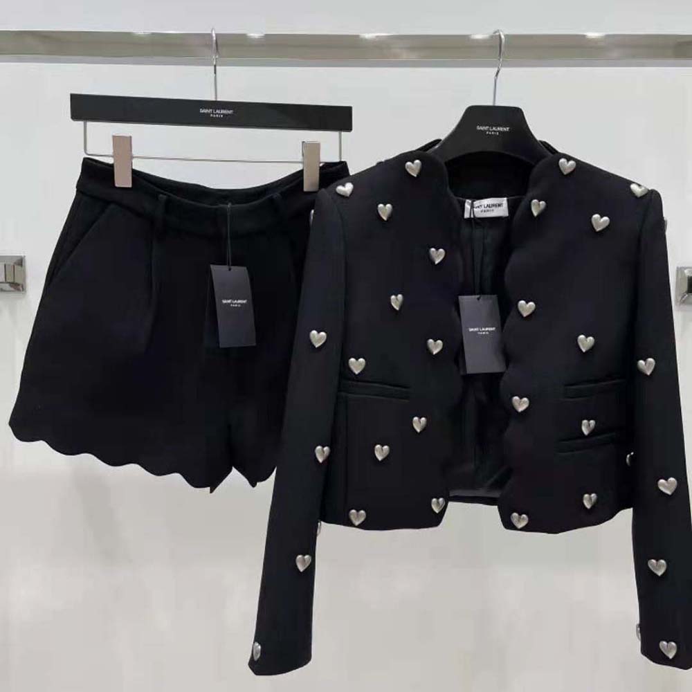 Close-up of black boucle fabric and YSL hardware on cropped jacket
