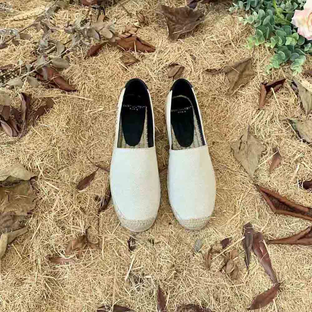 Close-up detail of YSL logo embroidery on espadrilles canvas upper