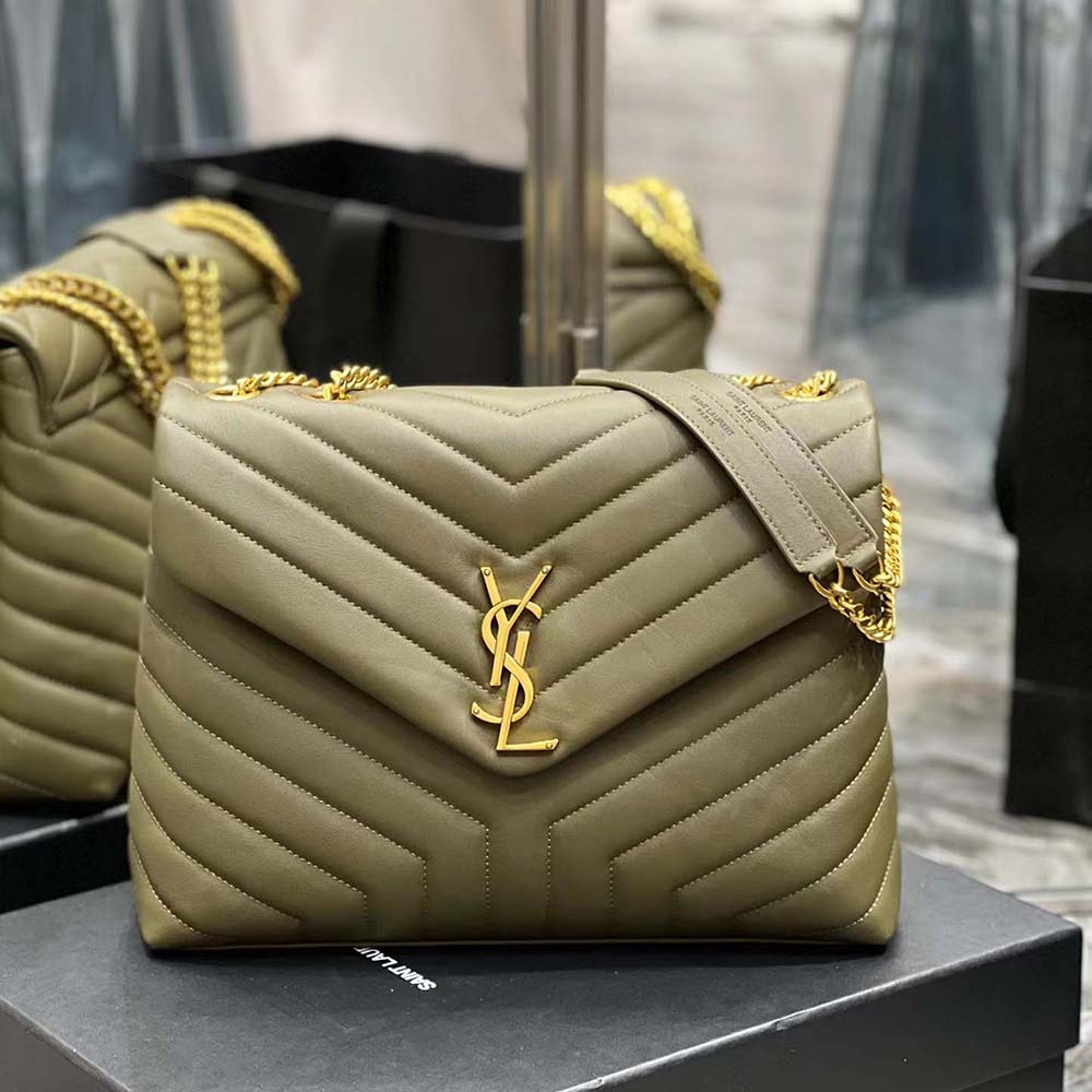 Close-up of gold YSL logo hardware on green Loulou Medium Bag