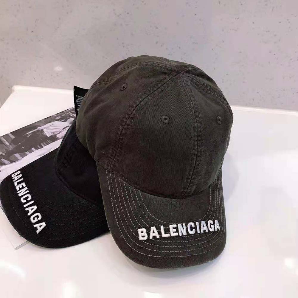 Side angle showing curved visor and adjustable strap on Balenciaga cap