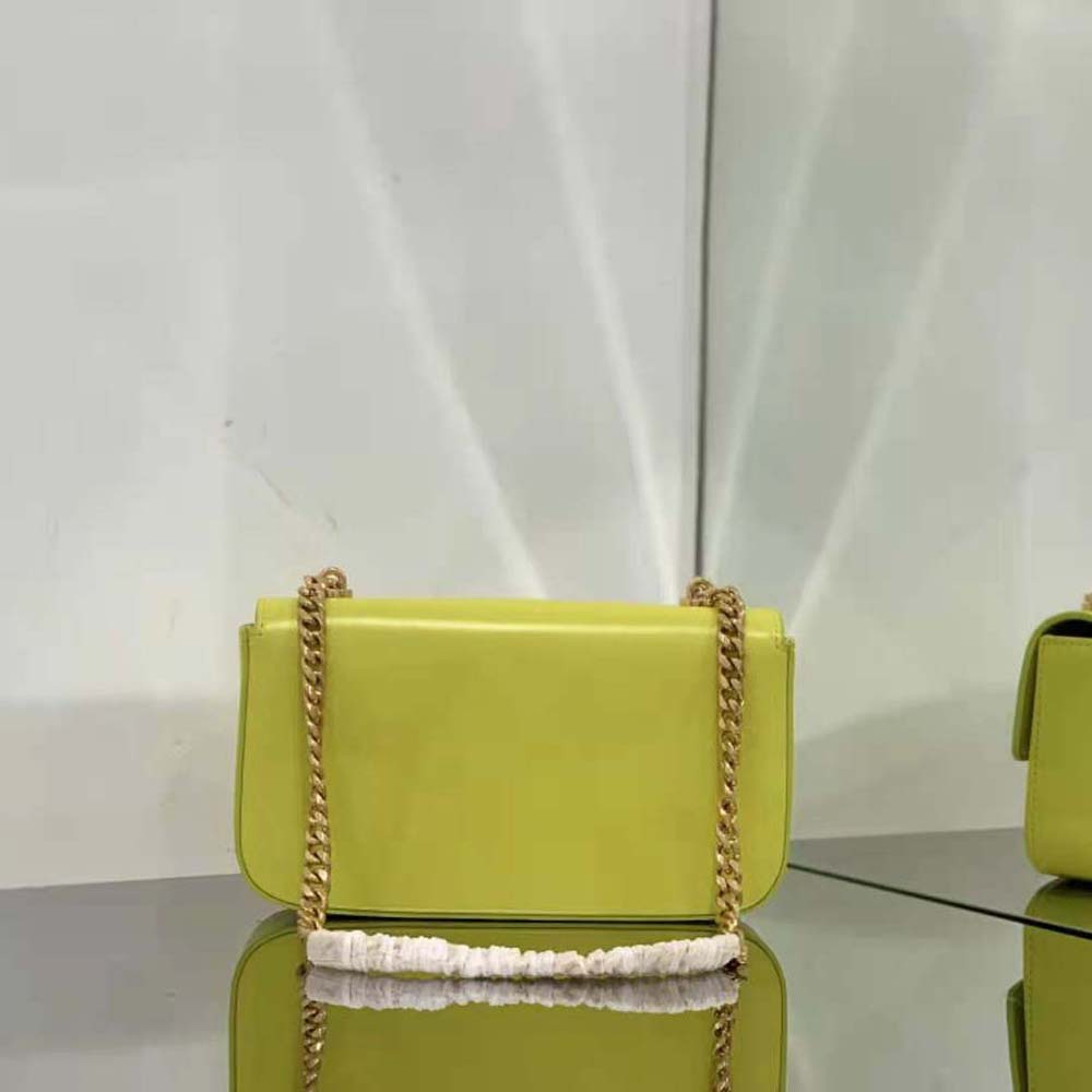 Side angle showing shiny yellow calfskin texture on Celine bag