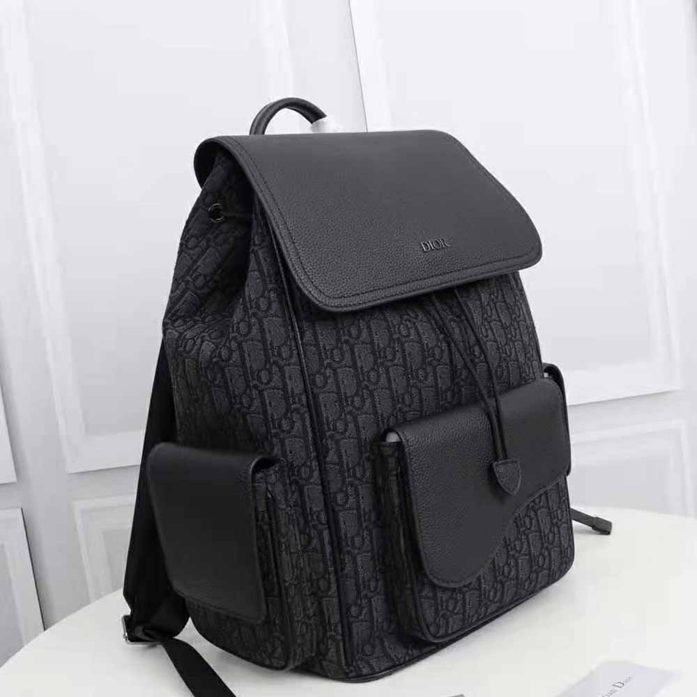 Side angle showcasing zipper and adjustable straps on Dior backpack