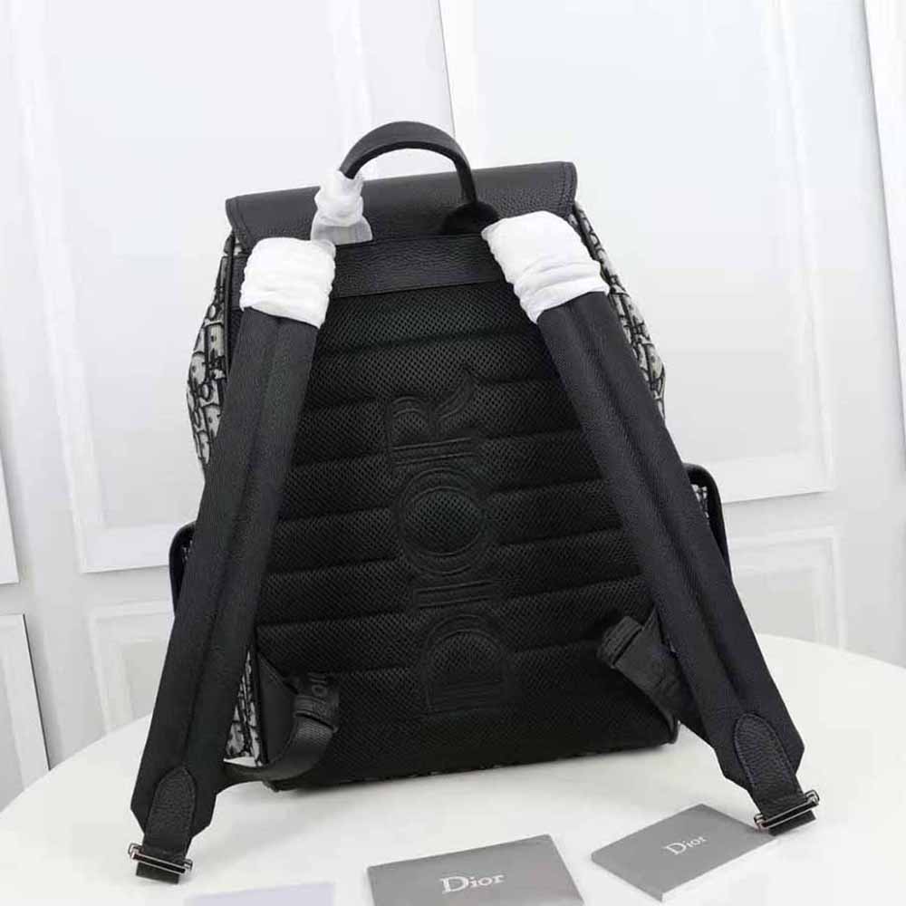 Side angle showing silver hardware on Dior Men Saddle Backpack Beige and Black
