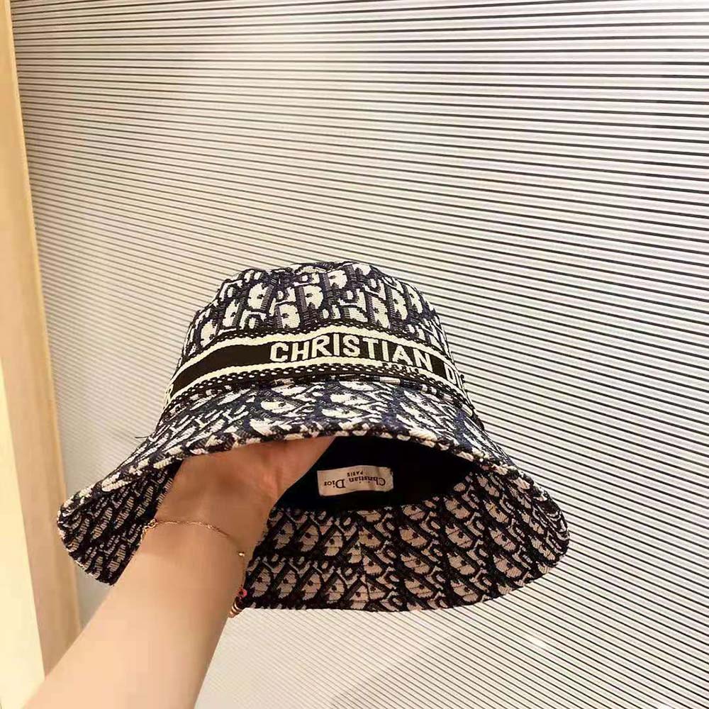 Side angle highlighting small brim and bucket silhouette in navy